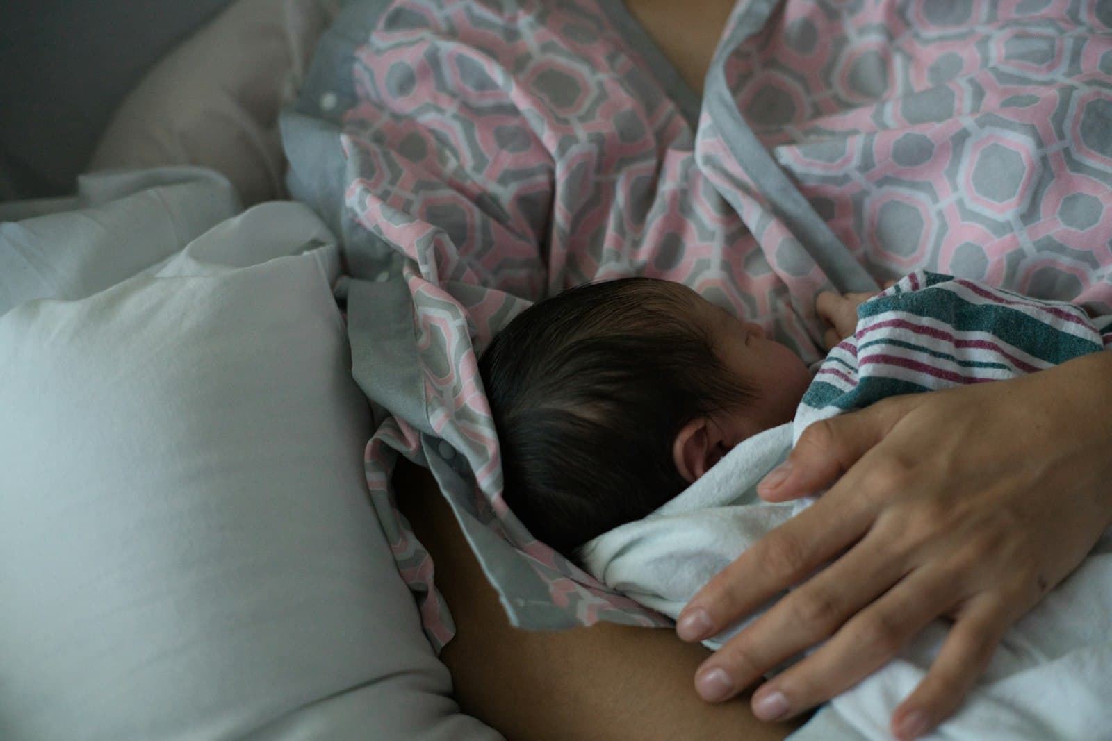 Parent breastfeeding their newborn baby